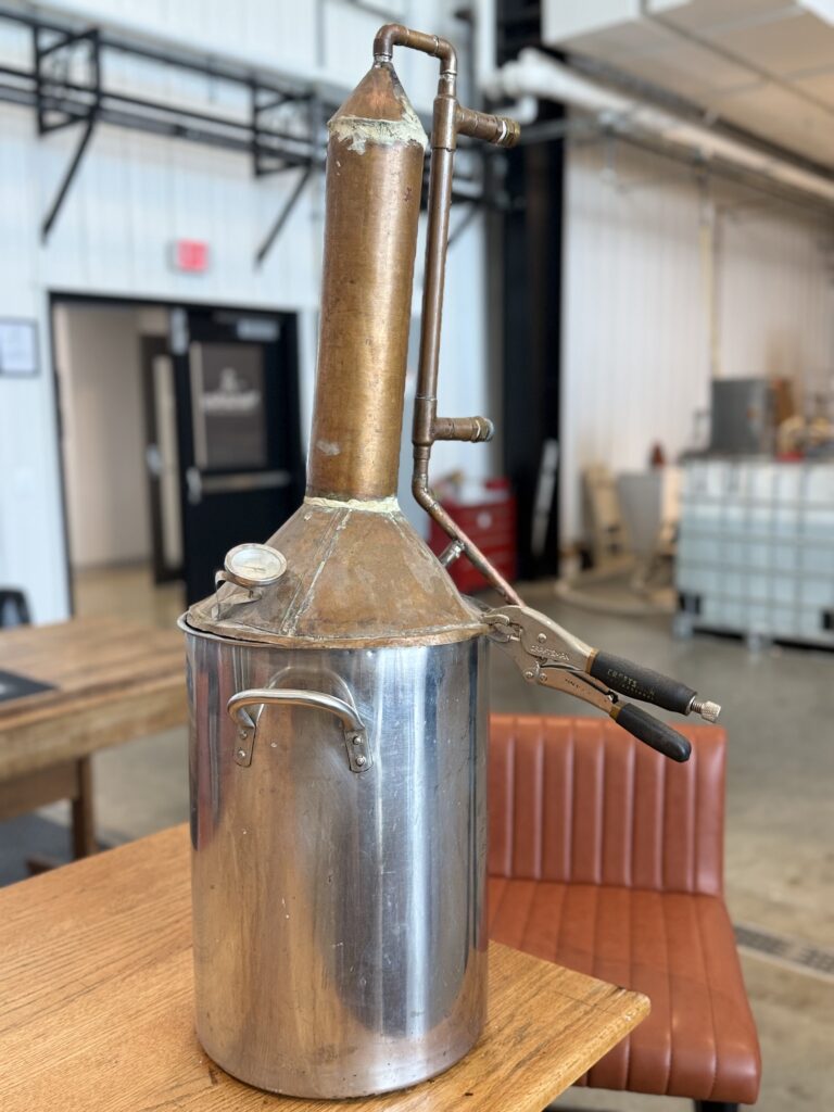 Kevin disappeared in the back for a short time and reemerged with this small still in hand with a mischievous grin. It was allegedly what he learned to distill on, though no one can prove it.