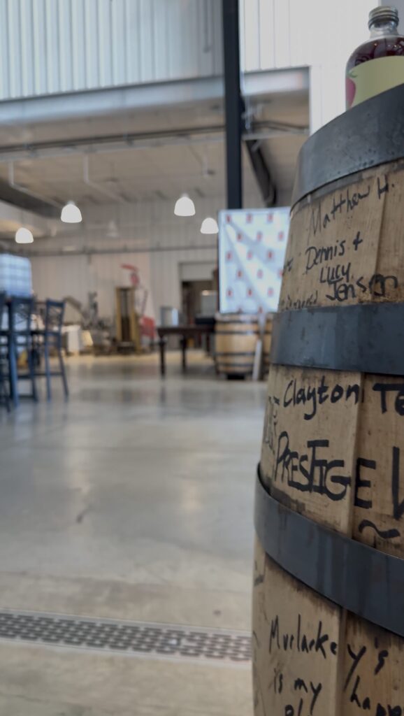 A barrel signed by numerous well known liquor stores and companies marks the entrance to the distillation and tasting room