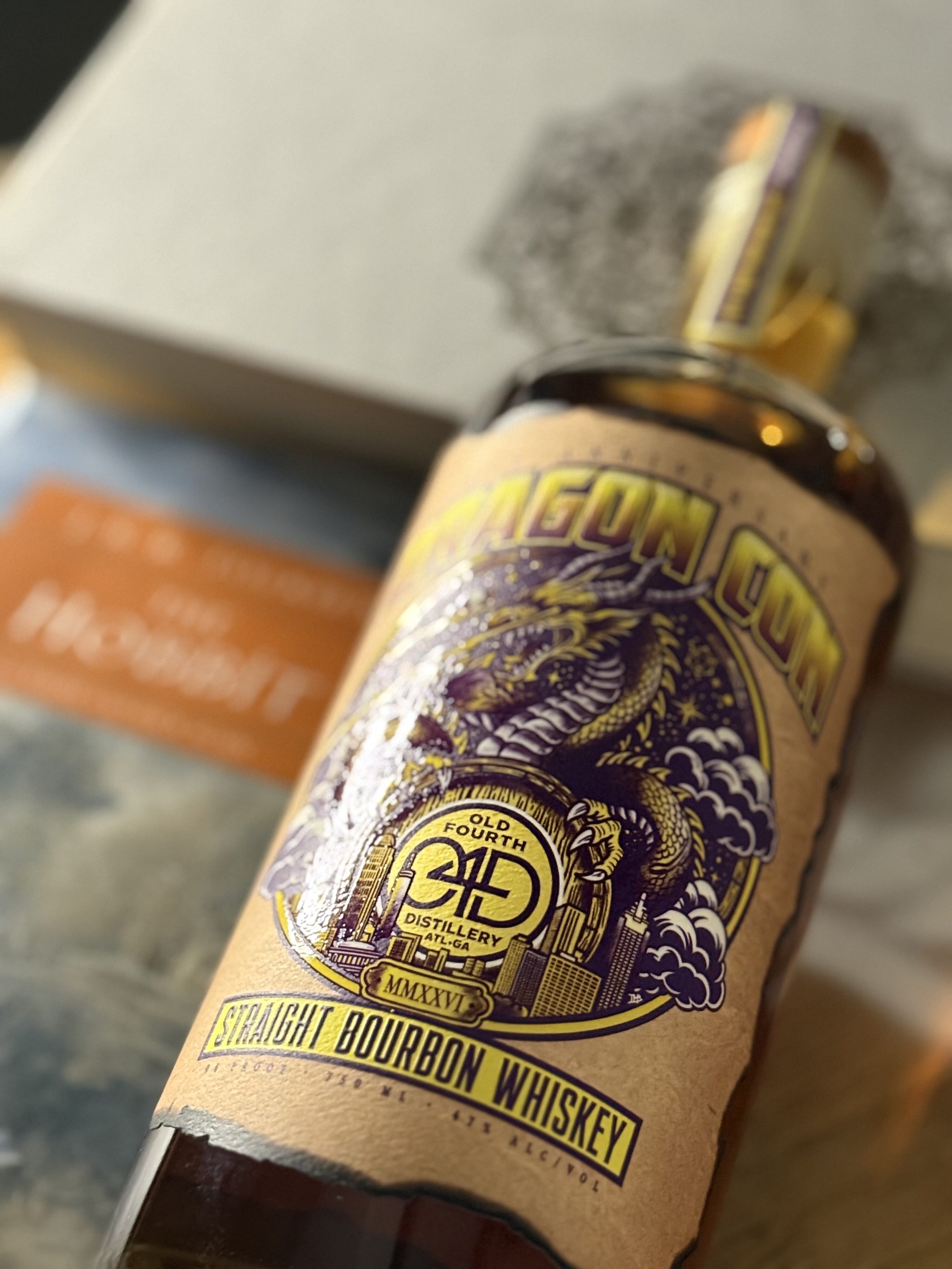 Old Fourth DragonCon 40th Anniversary Bourbon lies against JRR Tolkien's "The Hobbit"