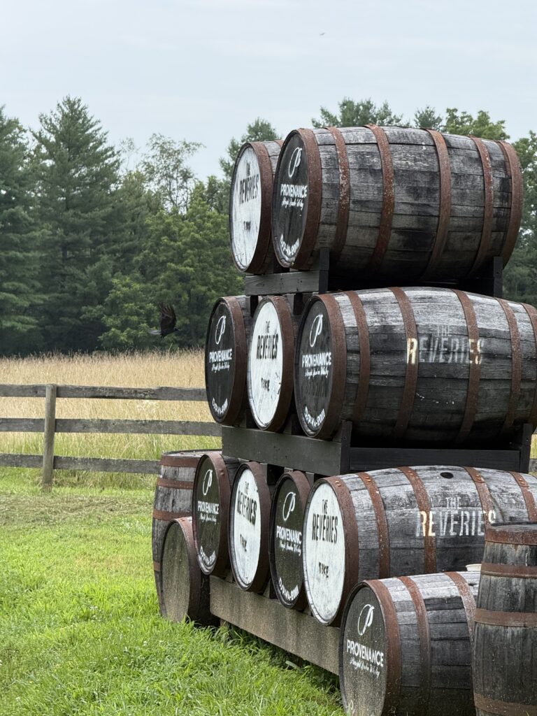 A crow flies near the stack of emptied Reveries barrels