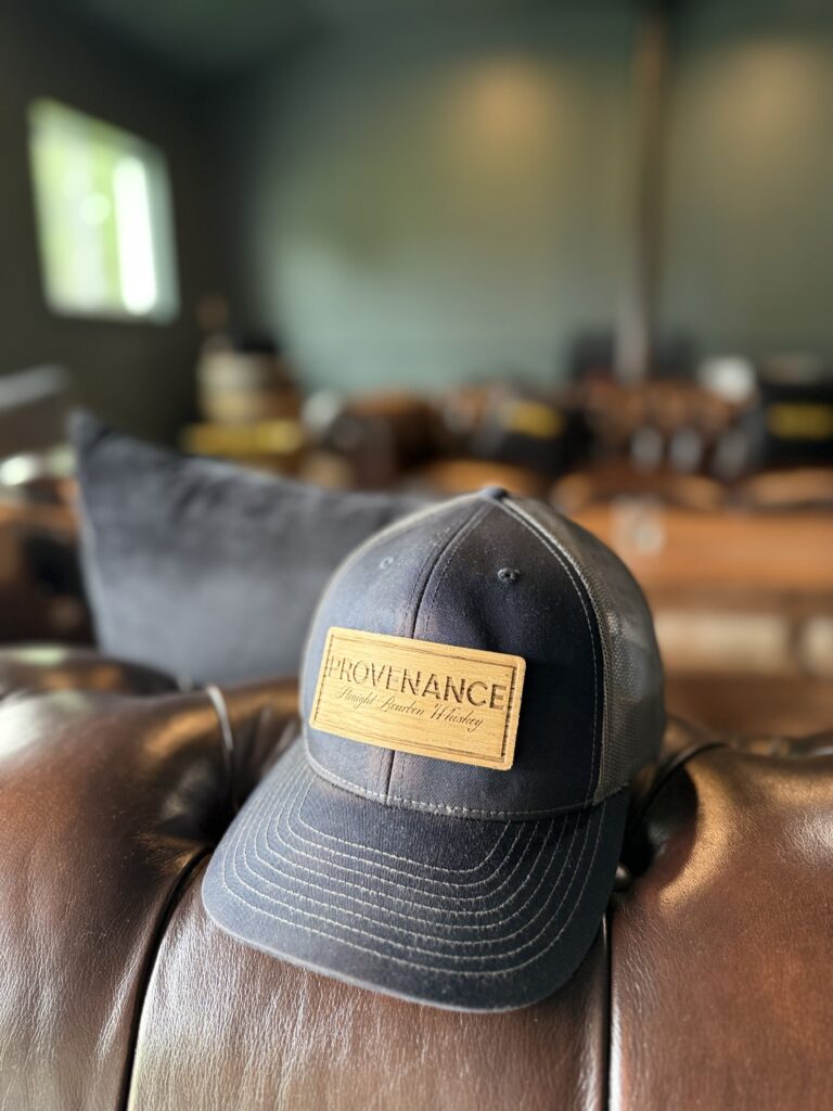 A Provenance hat sits on the leather couch in the BYO tasting room