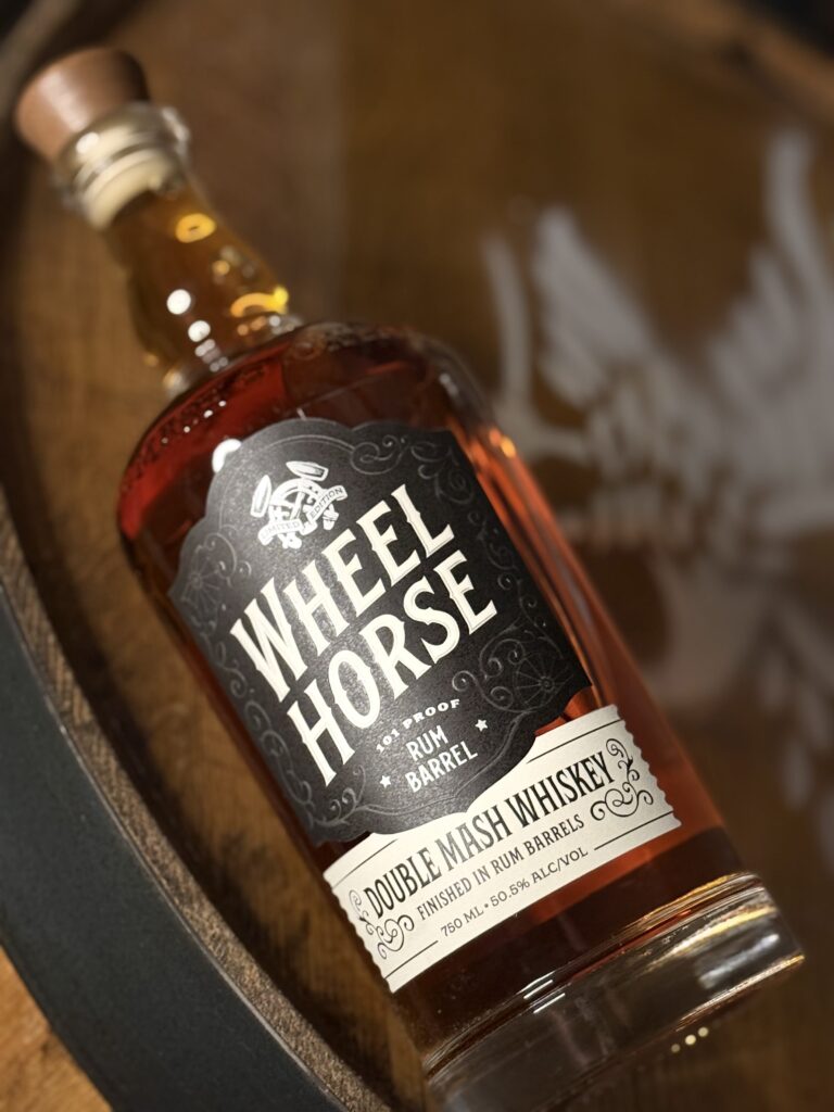 Wheel Horse's new 2026 release, a Double Mash Rum Finished Whiskey lying on barrel