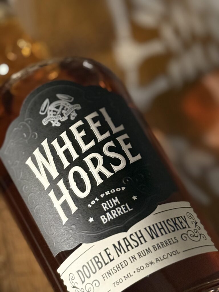Wheel Horse's new 2026 release, a Double Mash Rum Finished Whiskey lying on barrel close-up