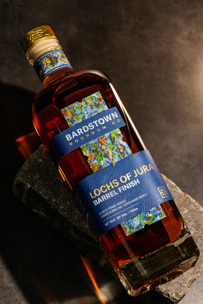 Bardstown Bourbon Company Lochs of Jura lying against dark wood grain