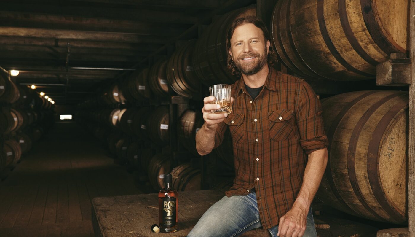 Dierks Bentley poses with a glass full of Row 94 whiskey (Image: Whiskey Riff)