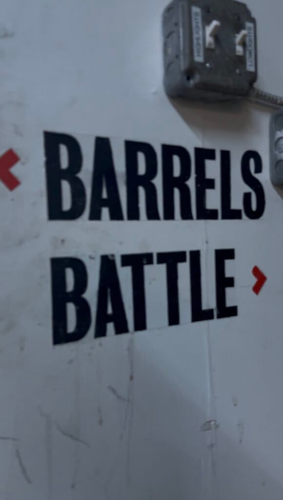 Arrows point opposite directions, one towards "barrels" and the other towards "battle", which is set between the fermenting and distilling rooms.