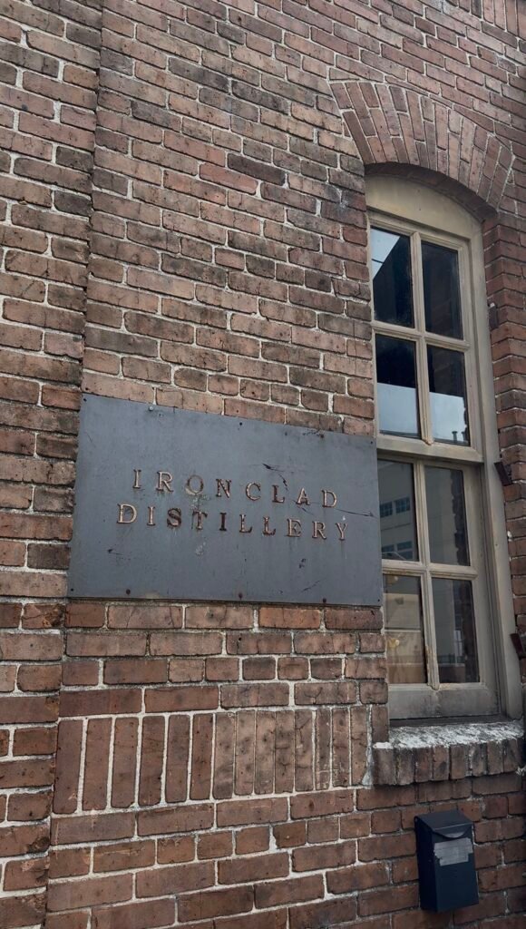 A simple metal sign denotes you came to the right place: Ironclad Distillery