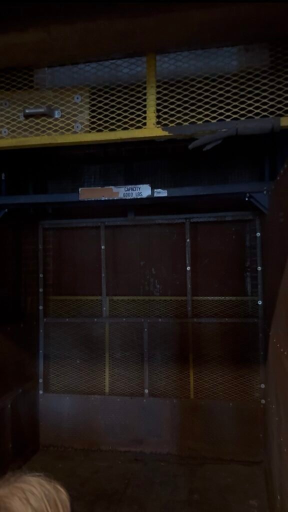The dark interior of the lift that brings people and objects floor to floor in Ironclad