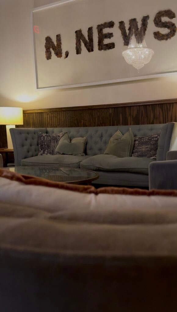Stylistic Newport News sign and comfortable couches in the lounge/tasting room