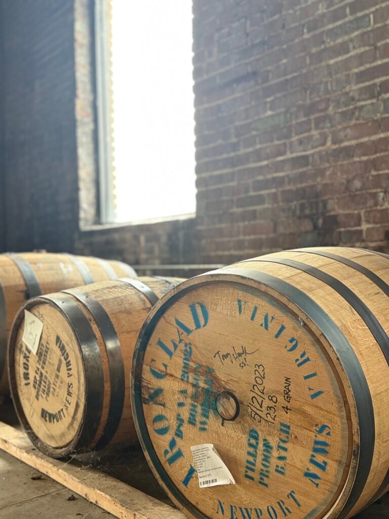 Signed barrels against the outer brick wall, including the one signed by Tony Hawk
