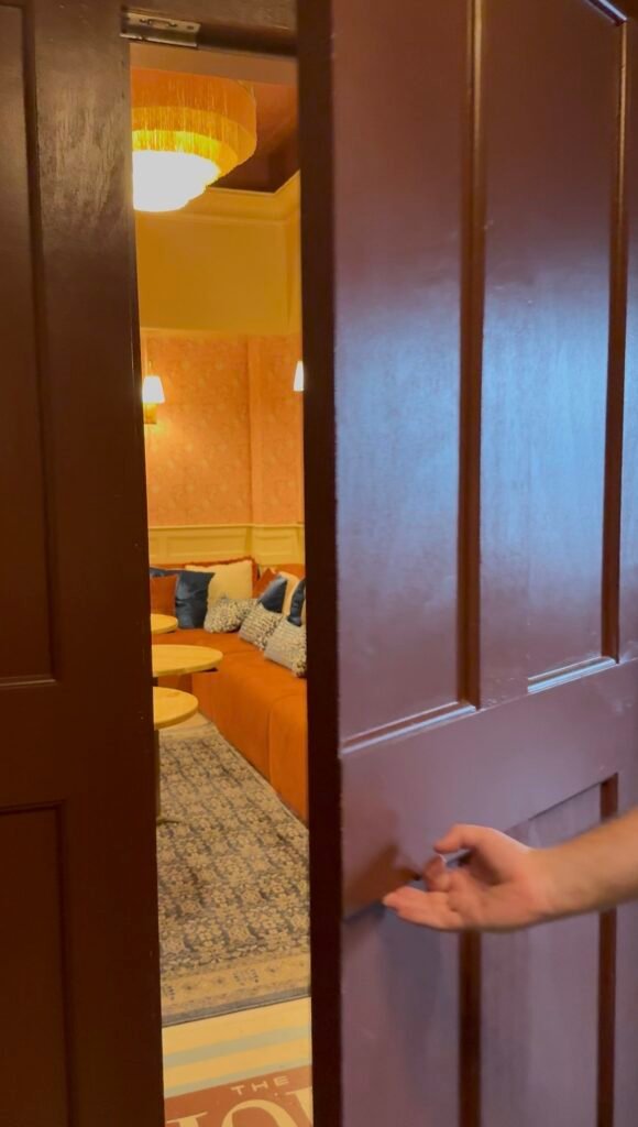 The hidden door cracks open to reveal an intimate speakeasy space for private rentals
