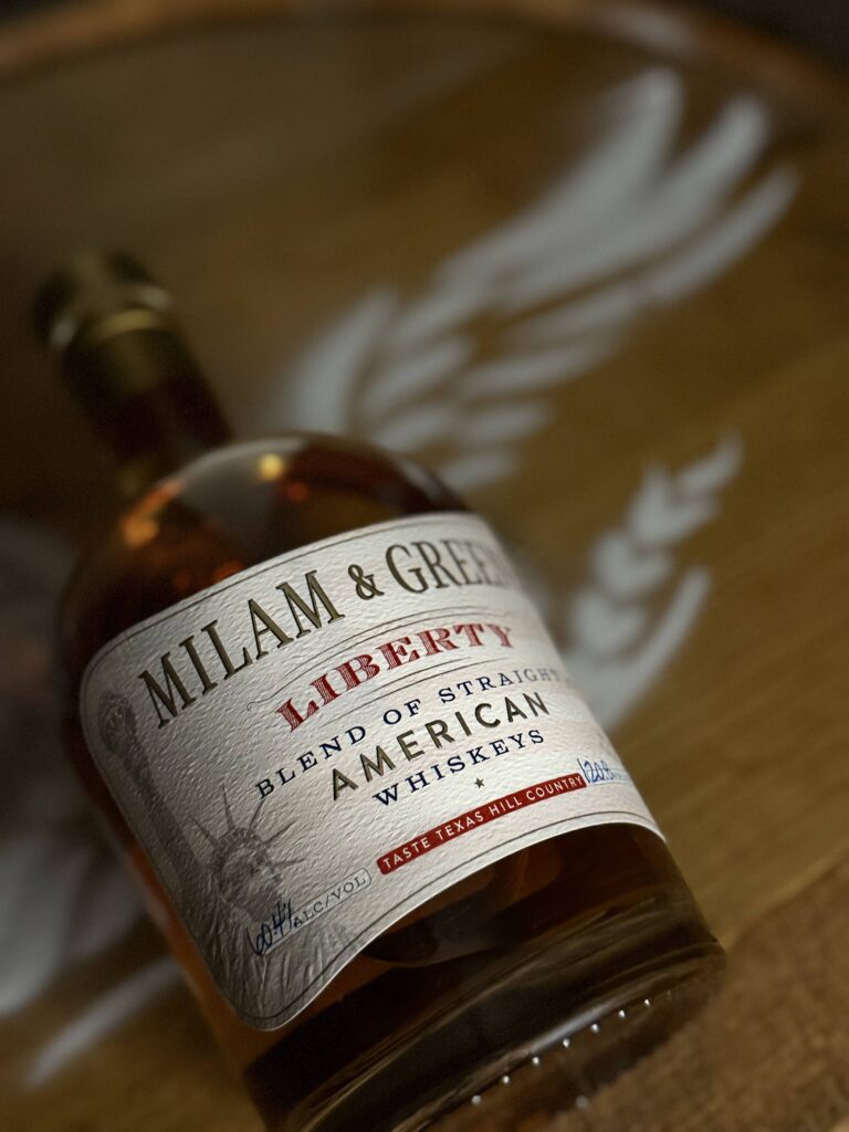 Milam & Greene's Liberty lies against Eagle whiskey barrel head logo