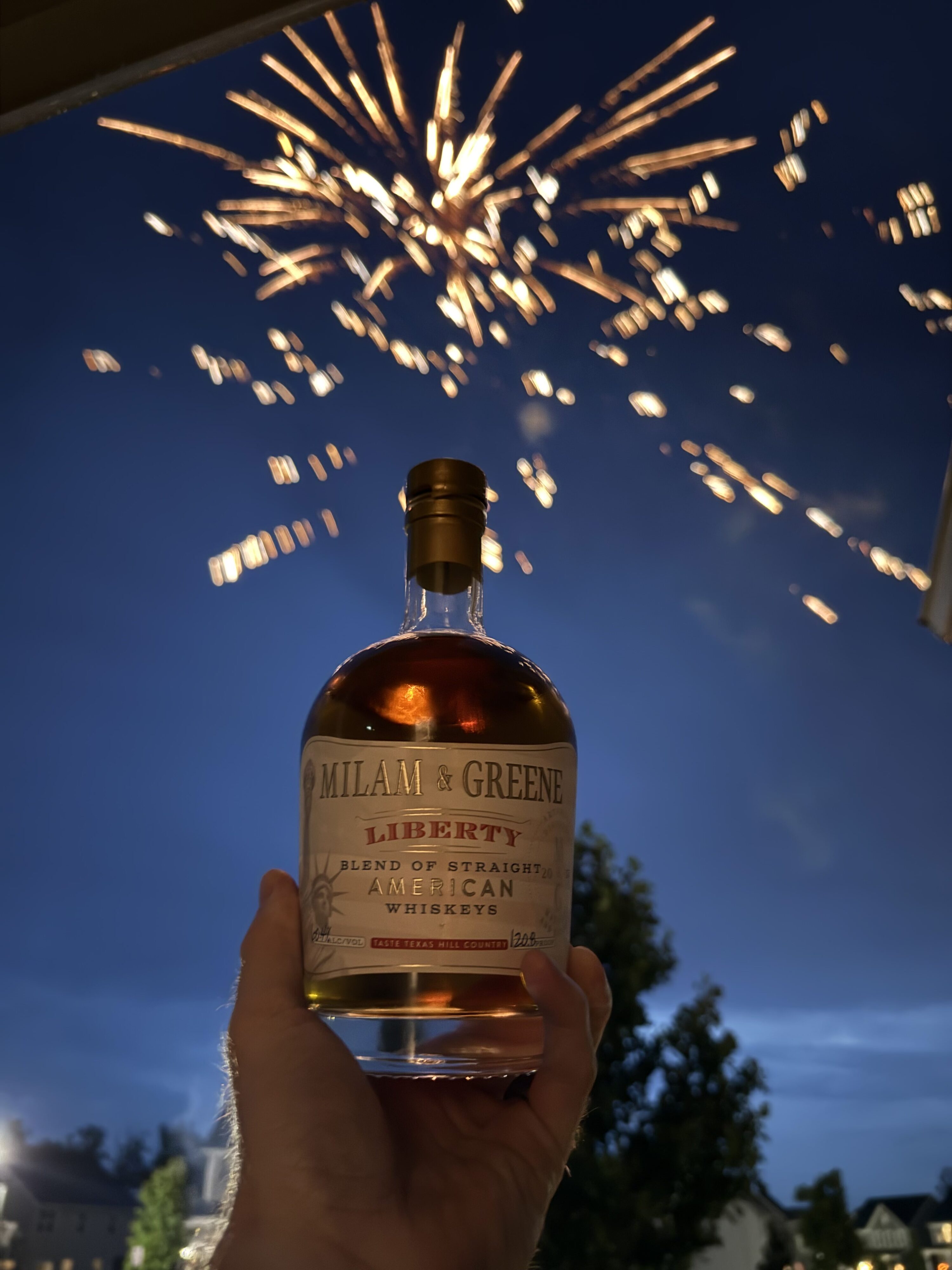 Milam & Greene's Liberty held up in front of Fourth of July fireworks