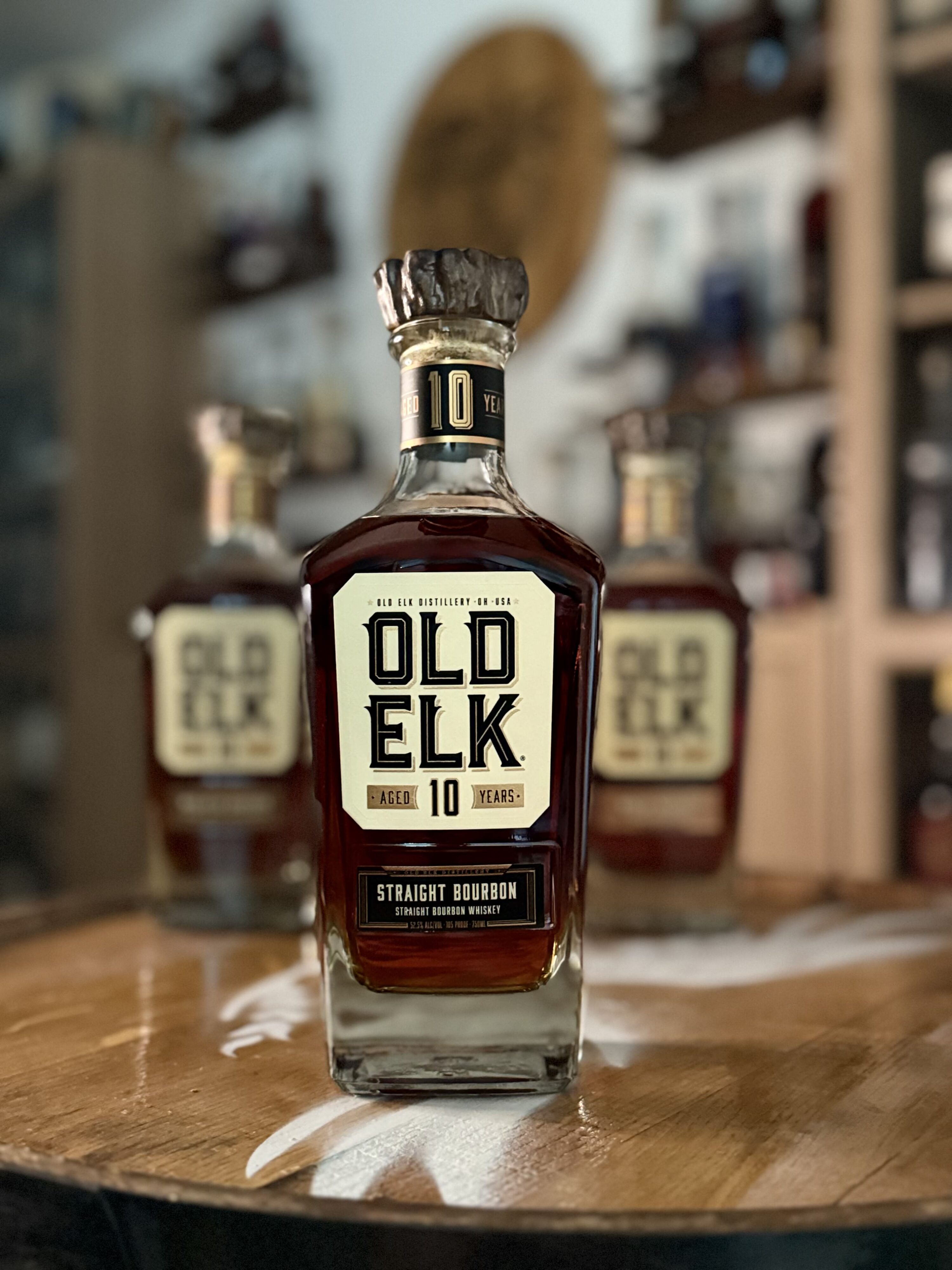 Old Elk 10-Year Bourbon with rest of collection blurred behind it