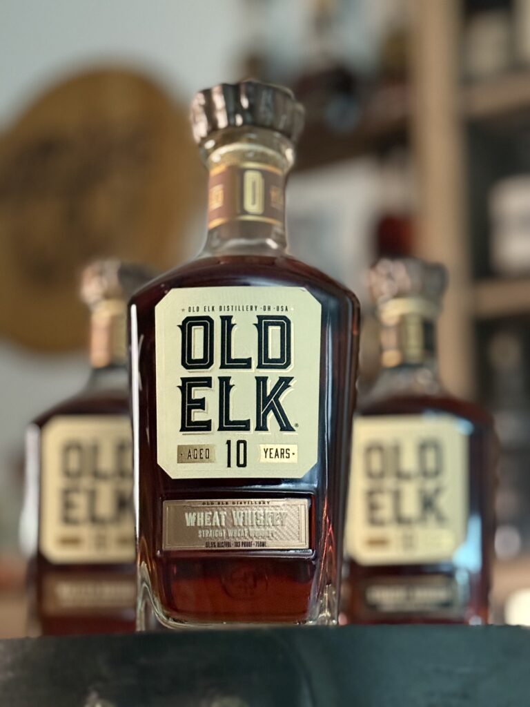 Old Elk 10-Year Wheat Whiskey from lower angle in front of rest of collection