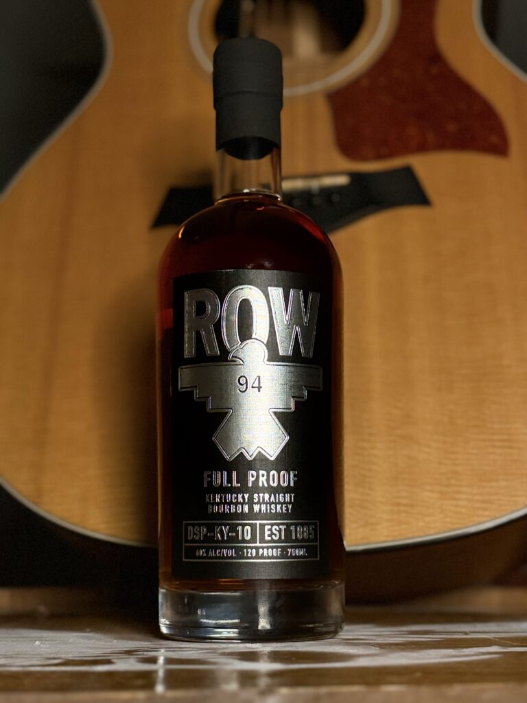 Row 94 Full Proof against standing guitar