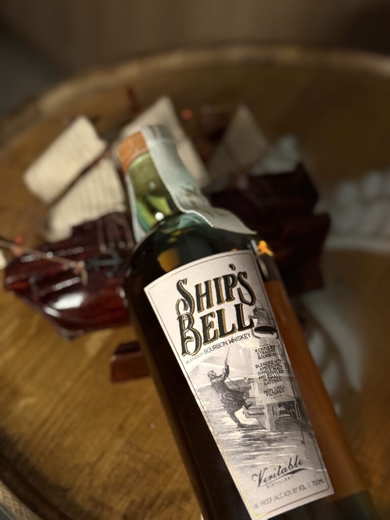 Veritable "Ships Bell" blended bourbon lying on model ship
