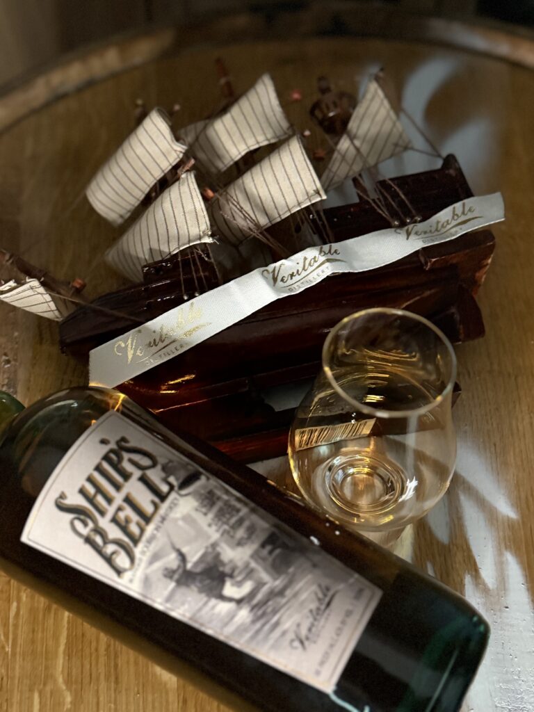 Veritable "Ships Bell" blended bourbon lying with full glencairn and model ship