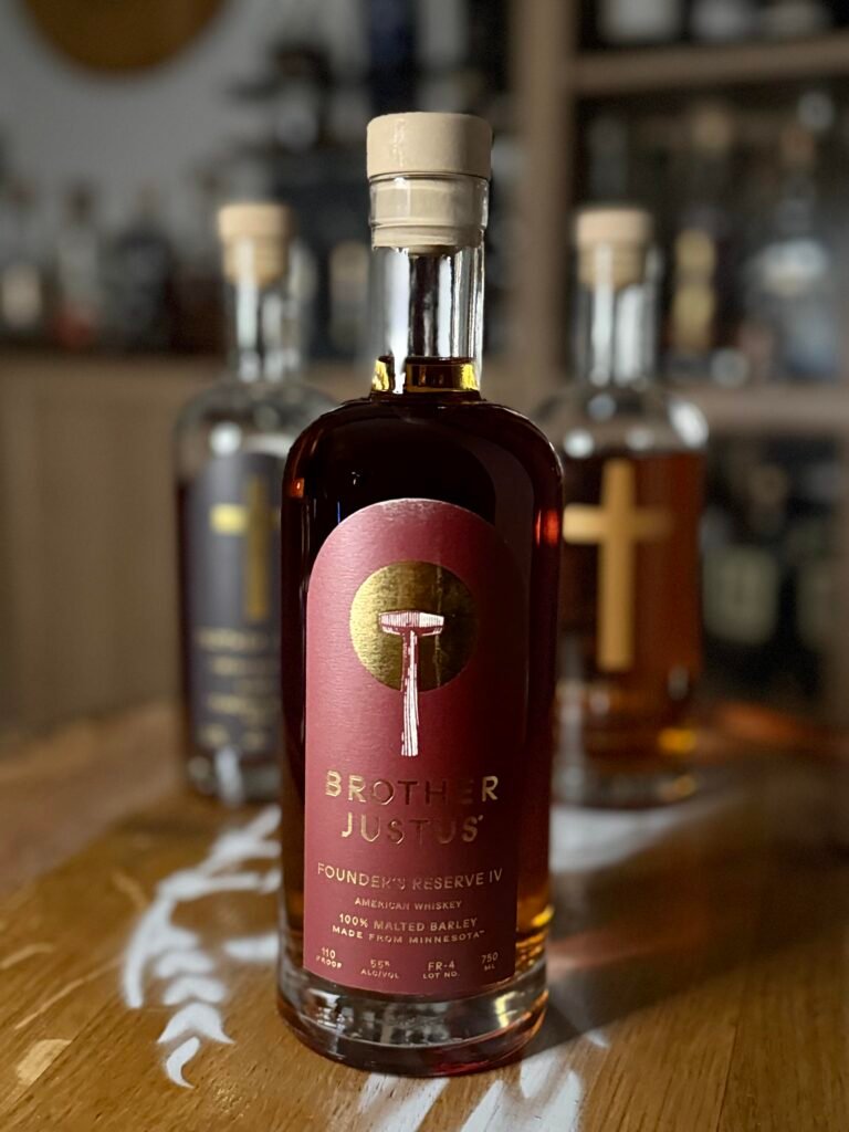 Brother Justus' Founder's Reserve IV sits in front of blurred past Founder's Reserve lll and ASM releases