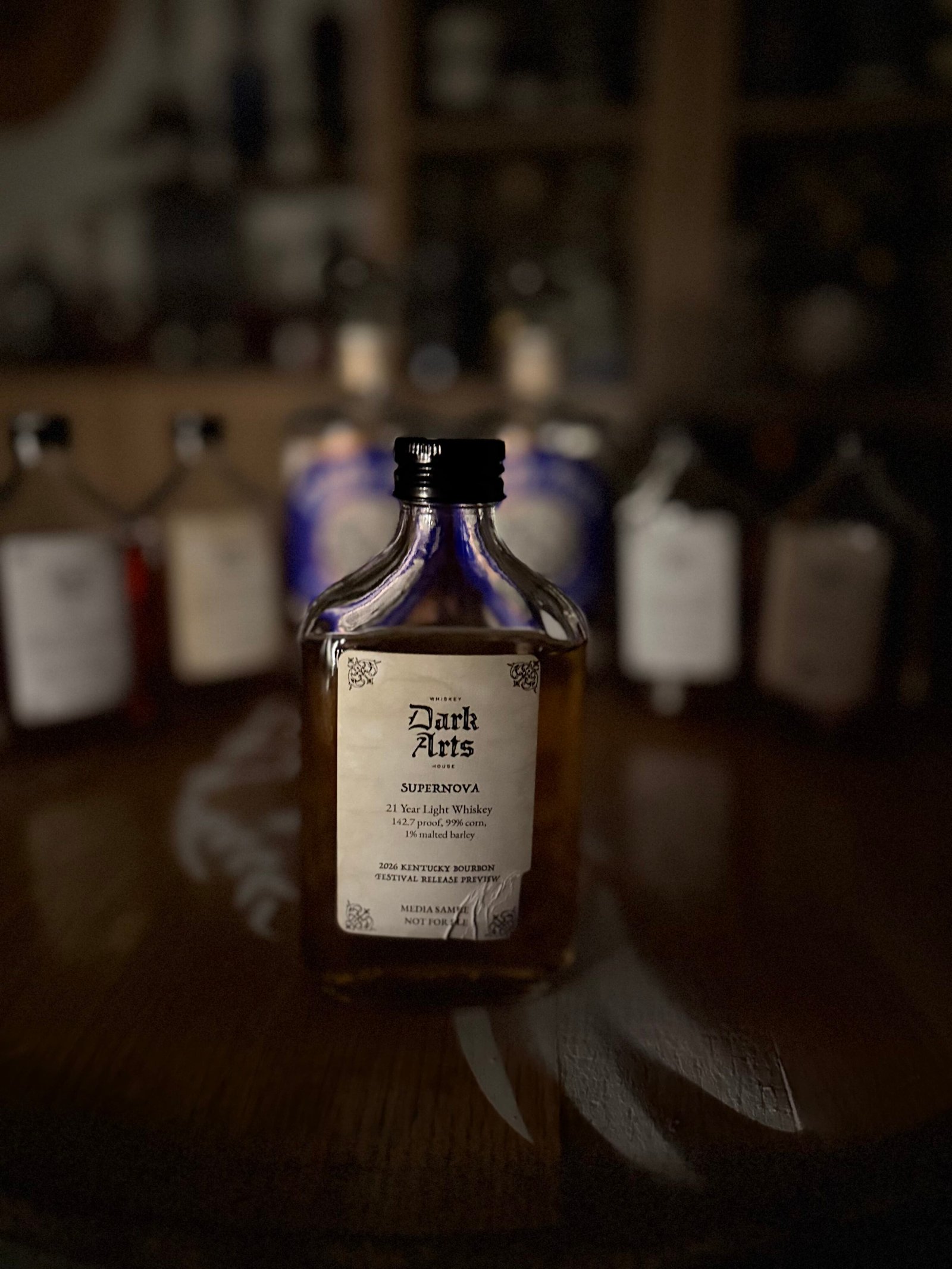 Dark Arts KBF Special Release: "Supernova" 21 Year American Light Whiskey in front of other 5 releases & past finished bottles