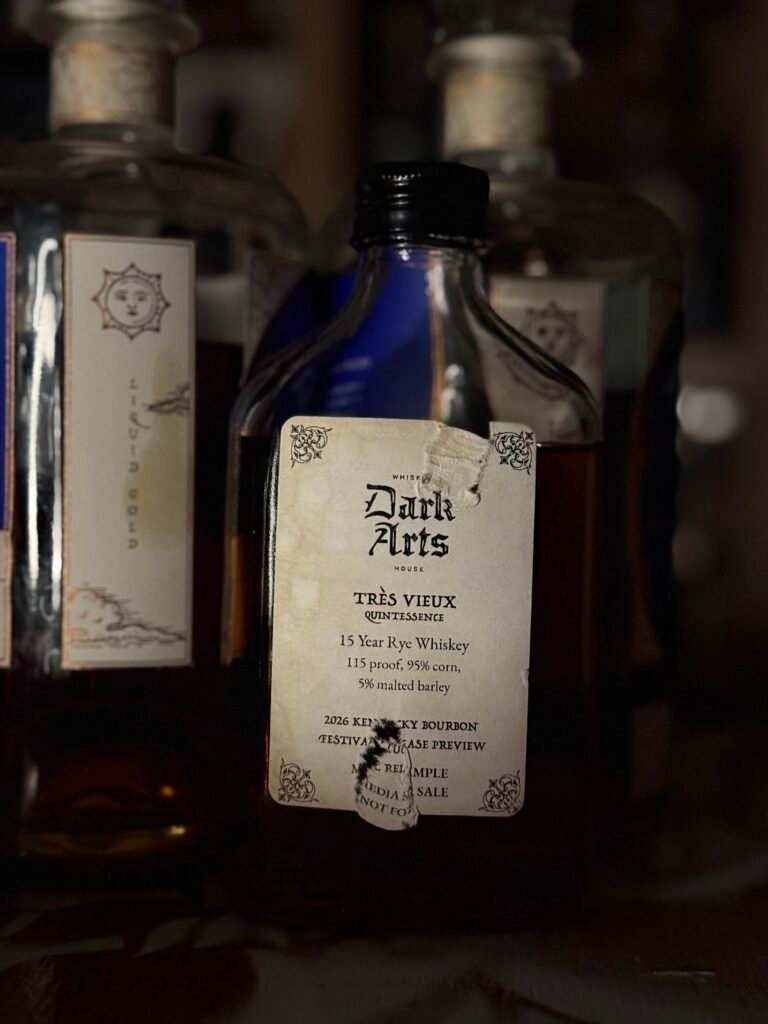 Dark Arts KBF Special Release: "Tres Vieux" 15 Year Rye beside "liquid gold" label on each Dark Arts bottle