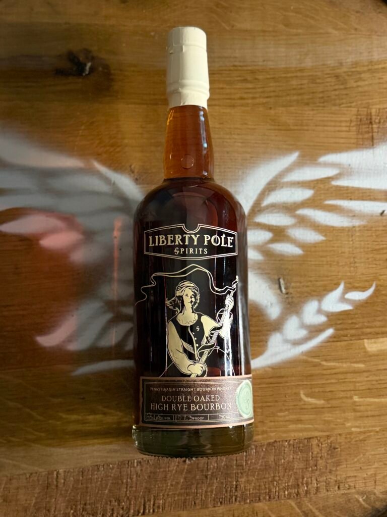 Liberty Pole Double Oaked High Rye Bourbon lying on eagle barrel head