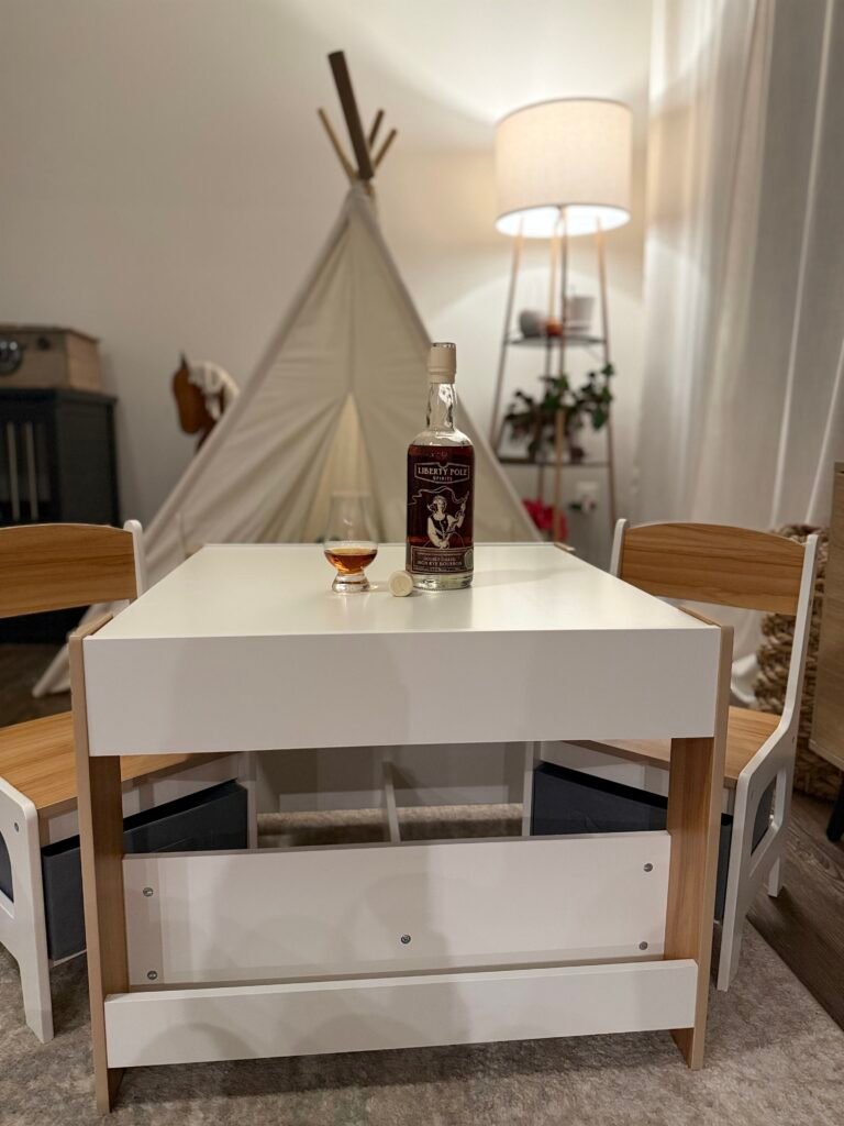 Liberty Pole Double Oaked High Rye Bourbon sitting on finished children's table - liquid encouragement for me to finish my project!