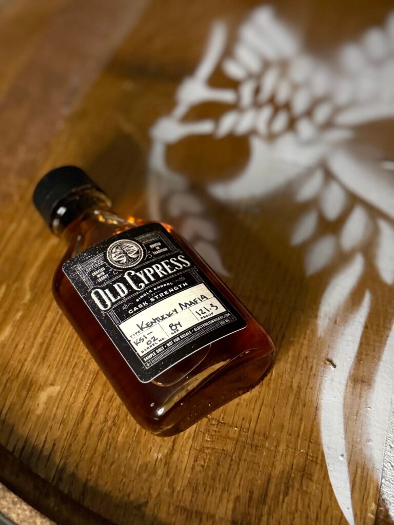 Old Cypress "Kentucky Mafia" Bourbon lying on eagle barrel head