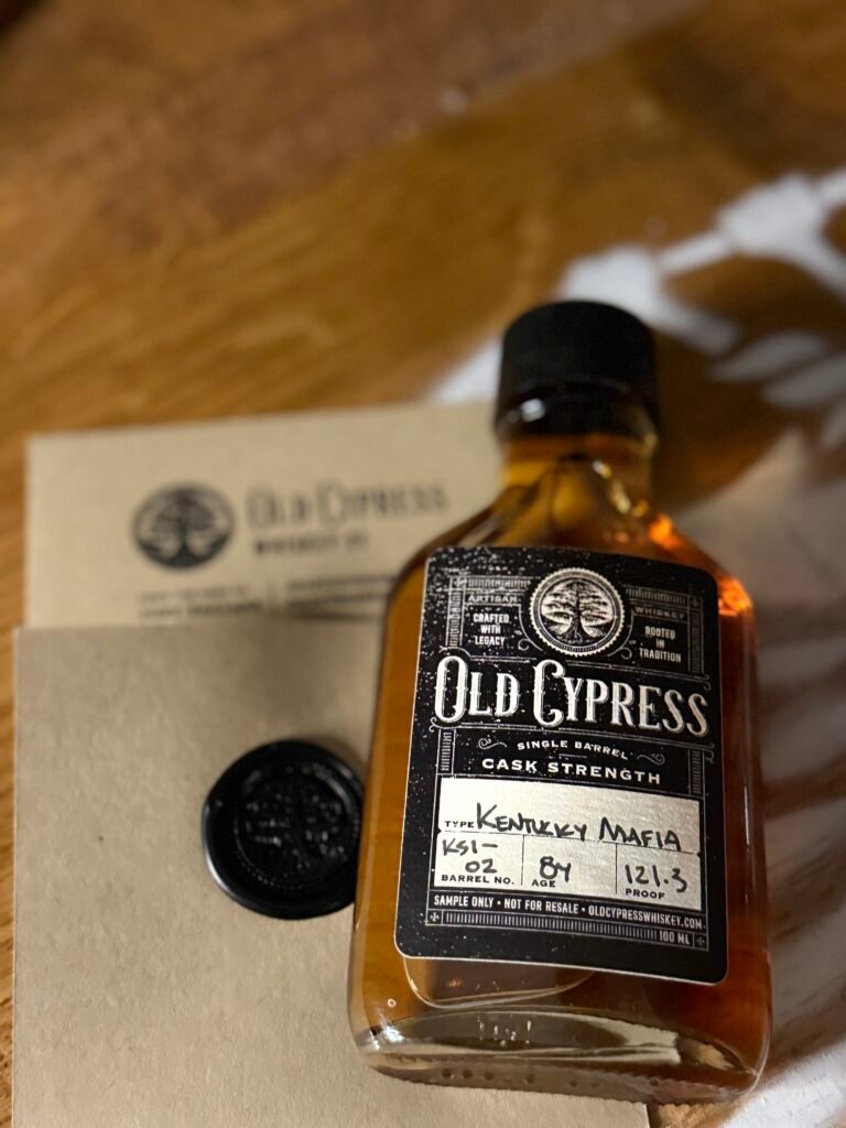 Old Cypress "Kentucky Mafia" Bourbon lying against sealed note