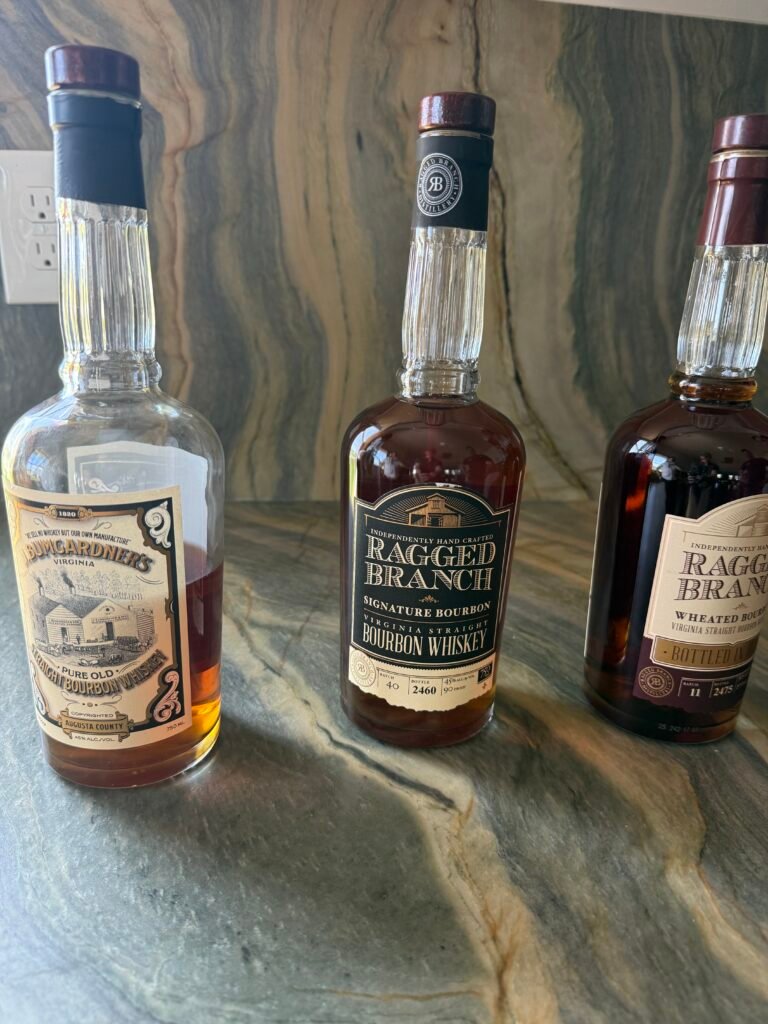 Line-up of three bottles including J. Baumgartner's, Signature Bourbon and their Wheated Bottled-in-Bond