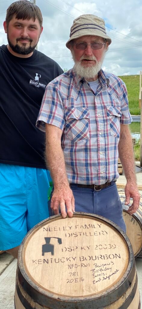 Royce Neeley & PaPaw in front of Neeley Family barrel