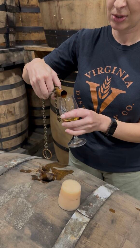 Amanda pours whiskey thieved straight from the barrel to ensure quality