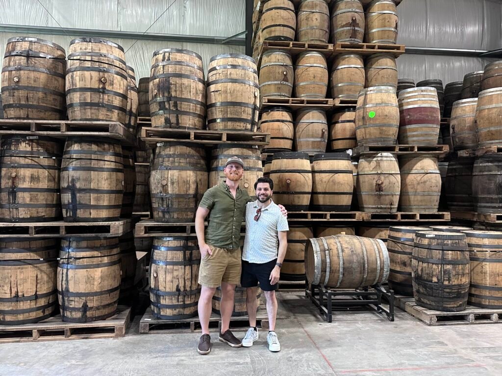 (Left to Right) Ethan Pope & David Aponte post in front of barrels in Cask House #1