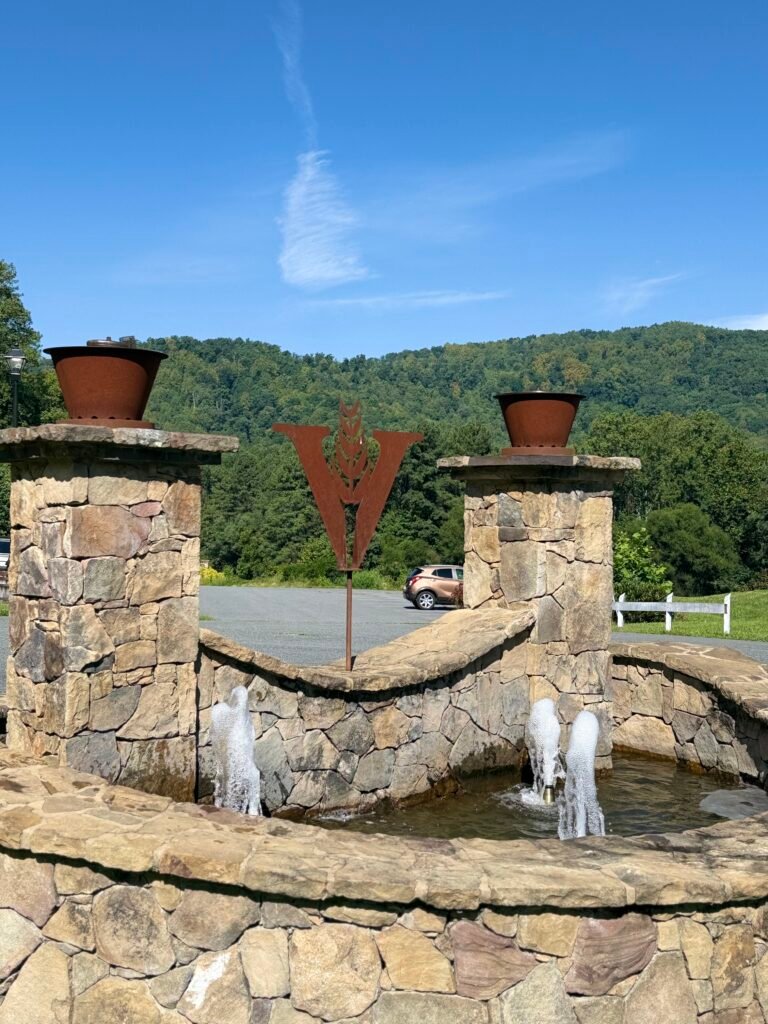 VDC logo fountain out front of tasting room showing the mountains surrounding the campus