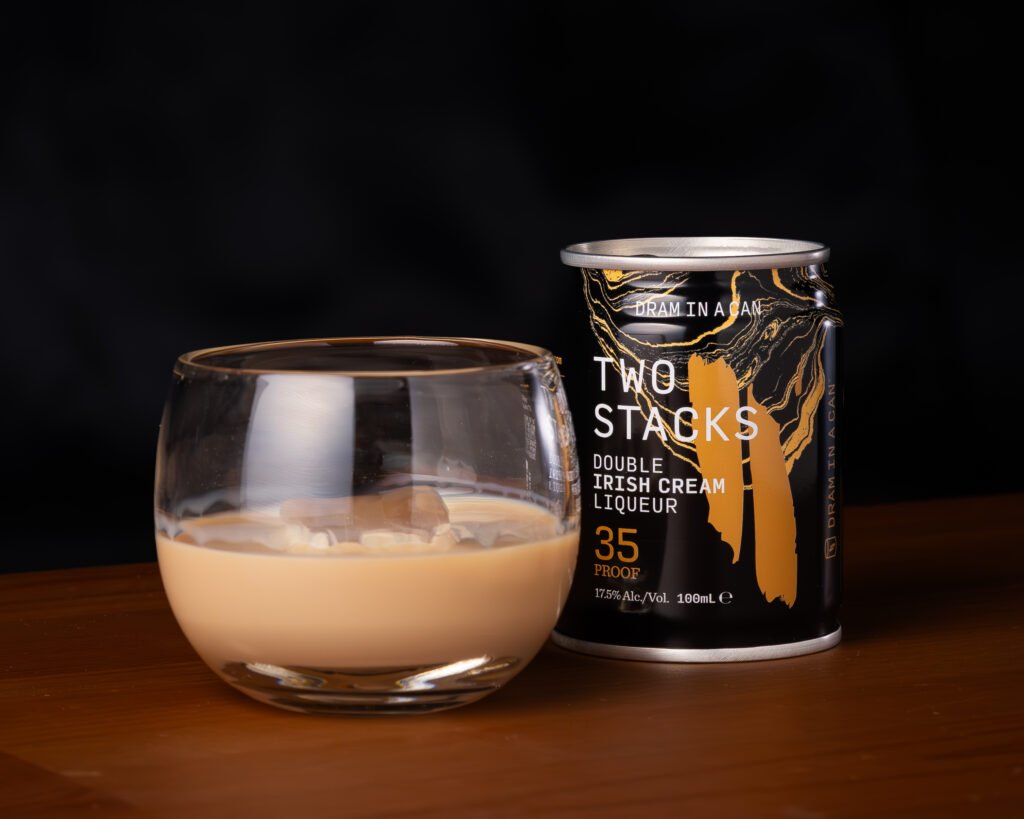 Two Stacks Double Irish Cream Liqueur Dram in a Can poured over ice in a rounded glass