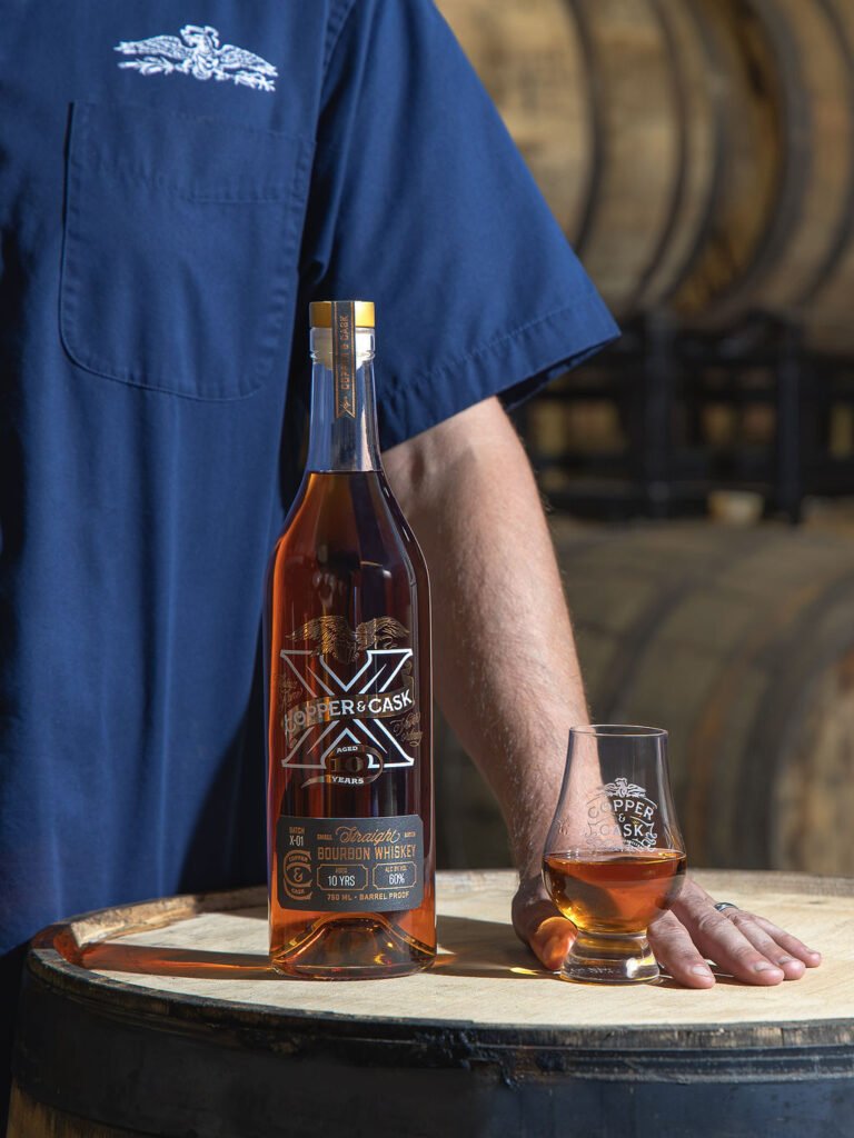Master Blender Stephen Corrigan stands near Copper & Cask's new "X" permanent barrel proof bourbon release