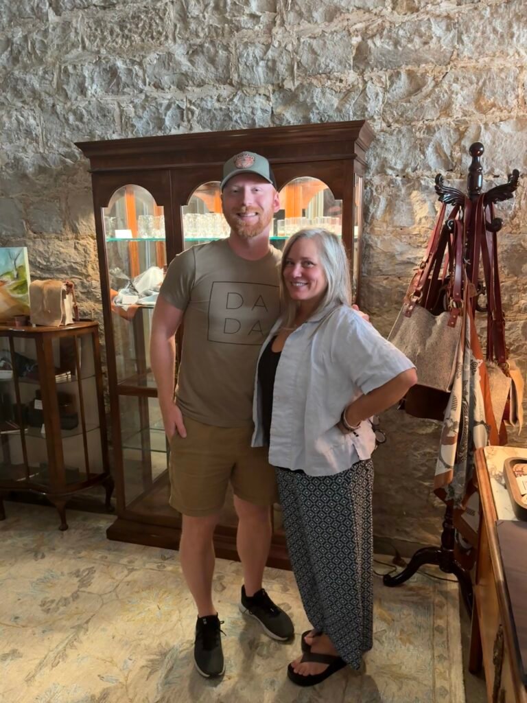 (L to R) Ethan Pope, Sherri Carter, stand in front of gift shop cabinet