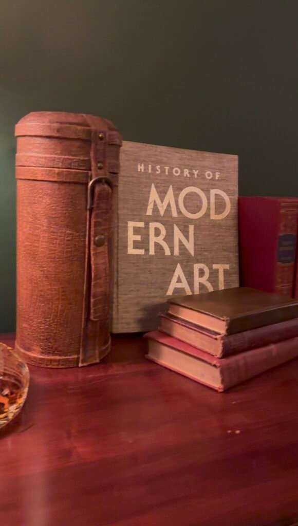 Books including one saying "modern art" on shelf