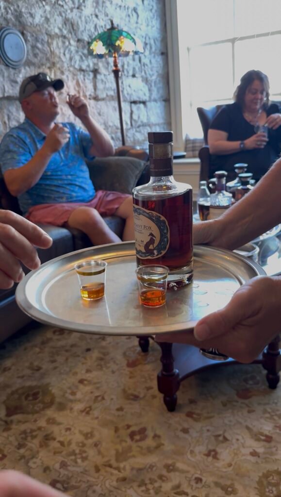 Mahogany Fox bottle with samples is offered on tray by Sherri Carter