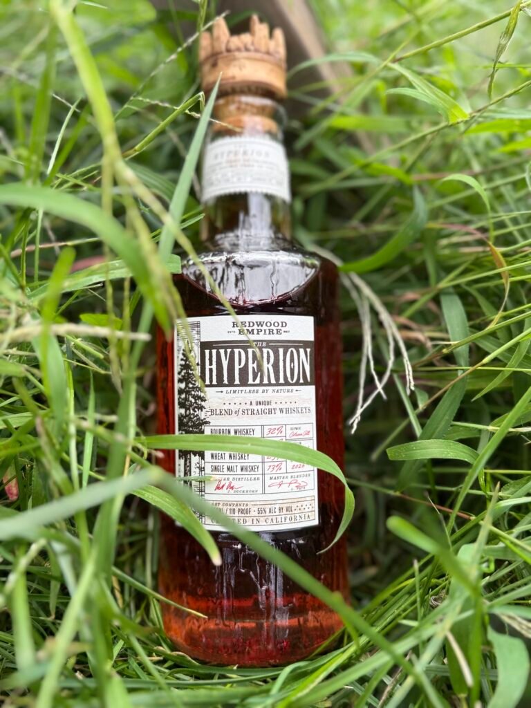 Redwood Empire The Hyperion whiskey lies in overgrown grass