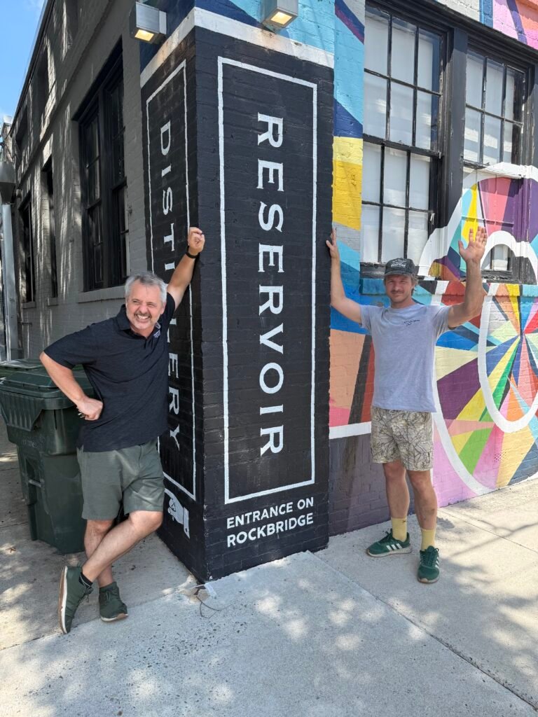 Dave and Nick strike a funny pose in front of the street art