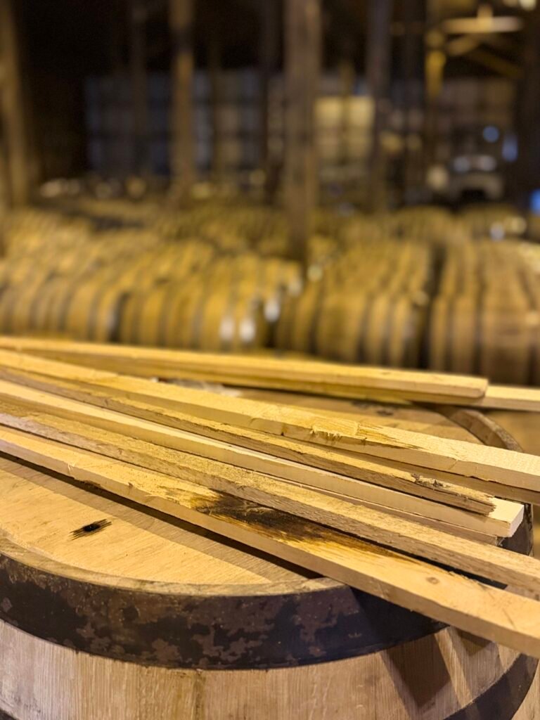 Wooden planks in front of blurred rickhouse barrels