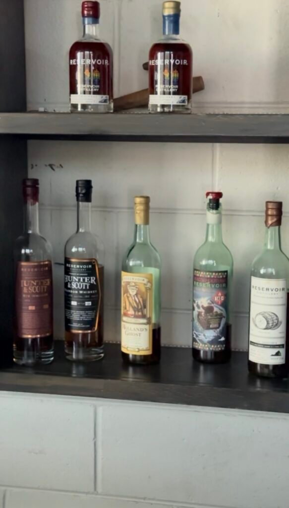 Row of 5 bottle line-up on tasting room shelf