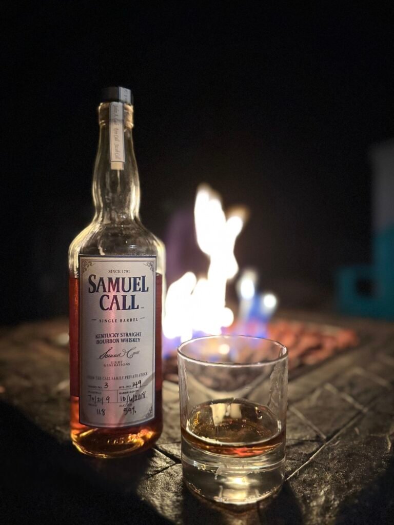 Samuel Call Barrel 3 sits in front of fire with full glass beside it