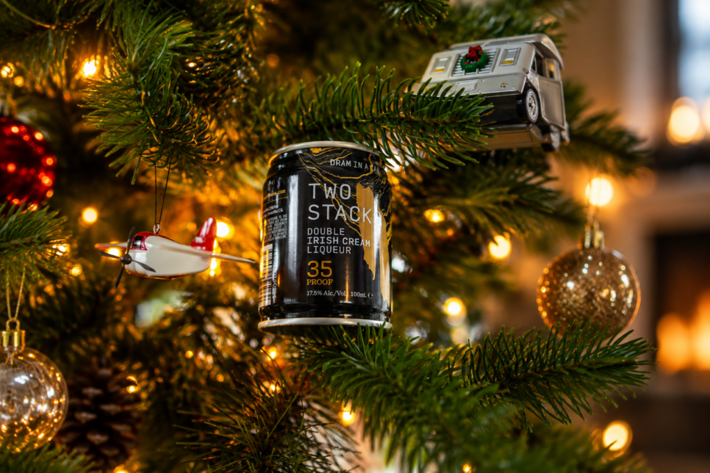 Two Stacks Double Irish Cream Liqueur Dram in a Can nestled against lights in a Christmas tree