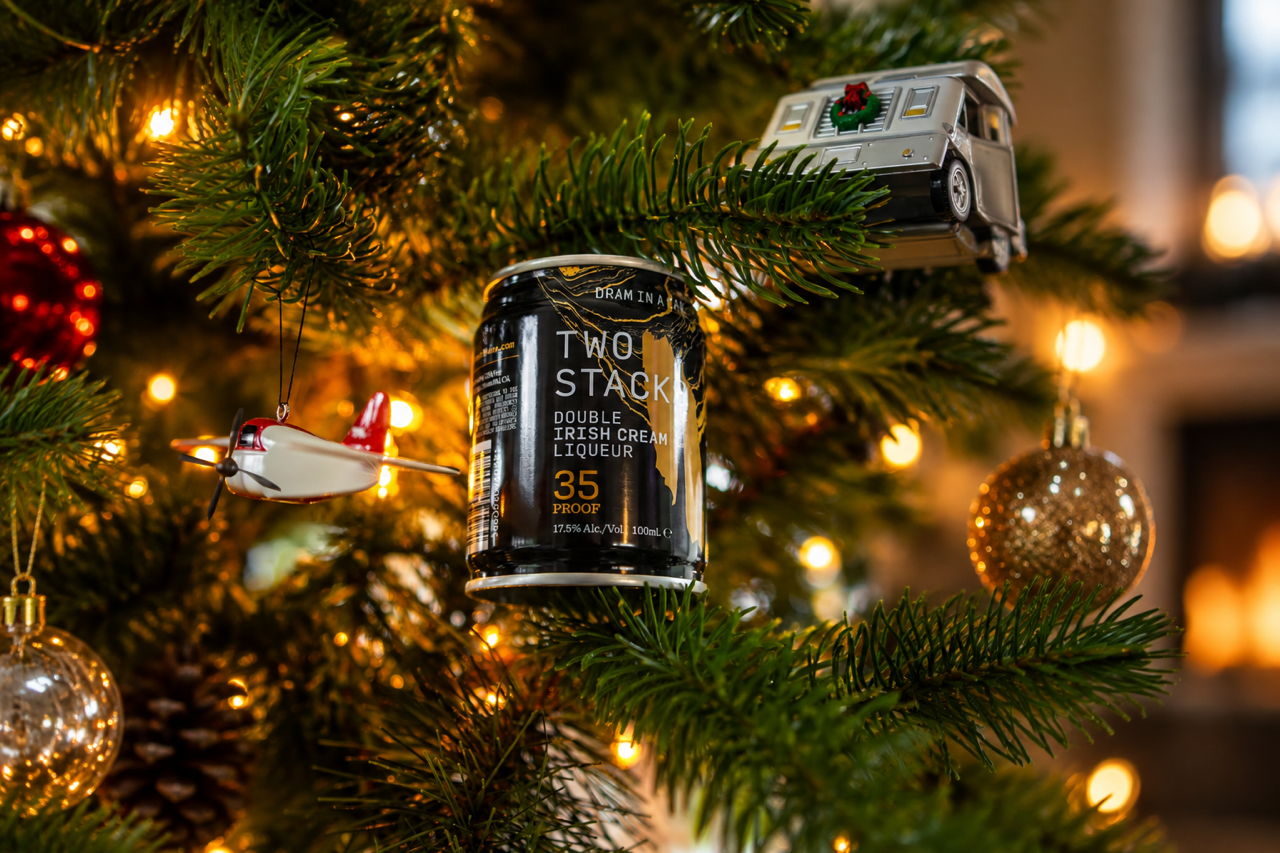 Two Stacks Double Irish Cream Liqueur Dram in a Can nestled against lights in a Christmas tree
