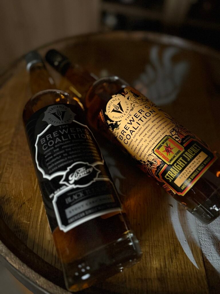 The duo release of Virginia Distillery Co's newest Brewer's Coalition releases: The Bruery "Black Tuesday" stout finished and Revolution Brewing Barleywine finished american single malts lie together on whiskey barrel head