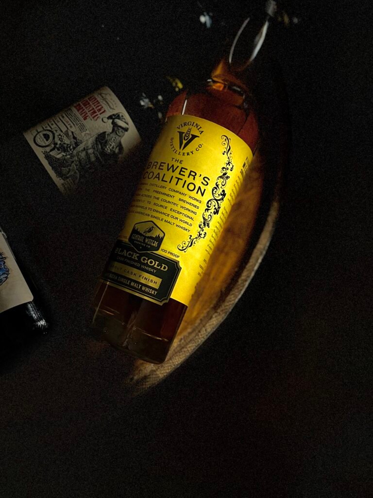 Virgina Distilling Co's Brewer Coalition "Black Gold" stout finished American single malt lies beside darkened stouts behind it
